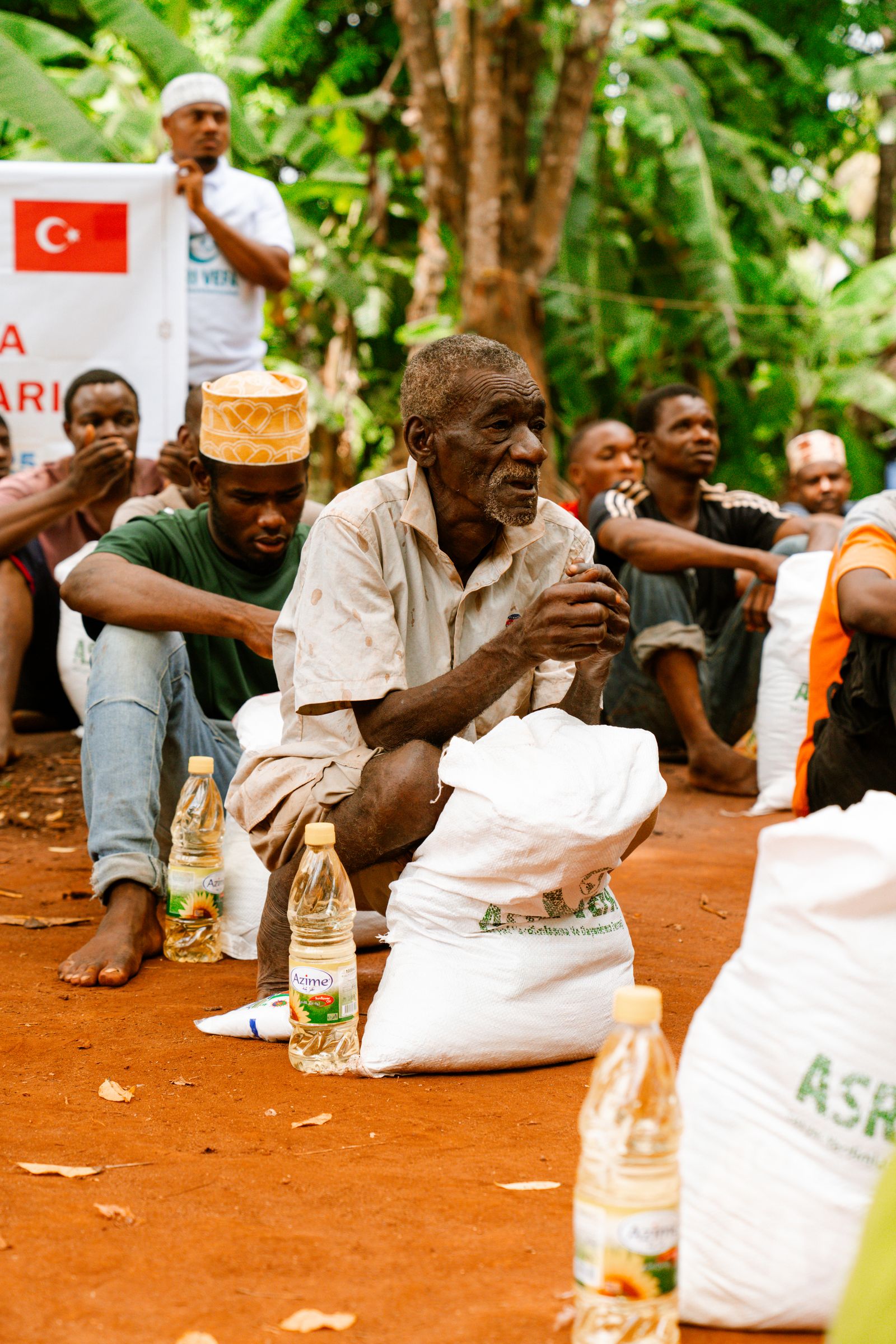 Community members gathered near groceries and household essentials